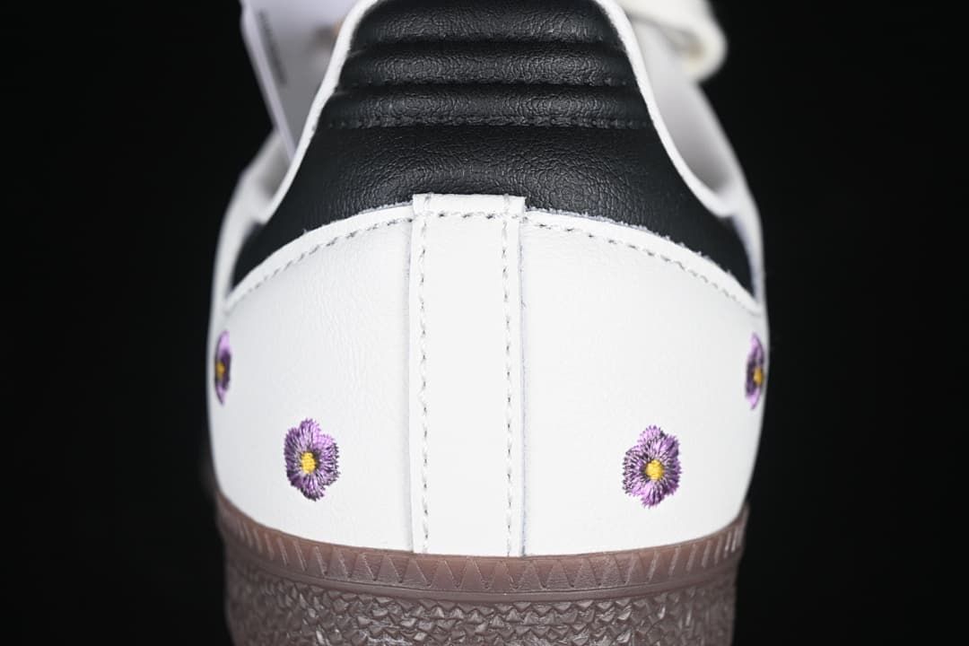 Rear view showing black heel tab and purple embroidered flowers