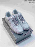 Pair of gray patterned Nike Air Force 1 low-top sneakers on a shoebox