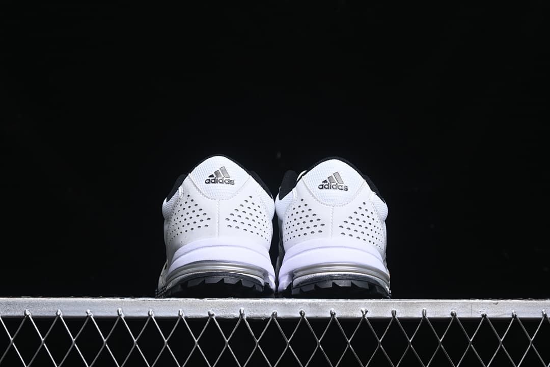 Rear view of both sneakers showing perforated heel panels