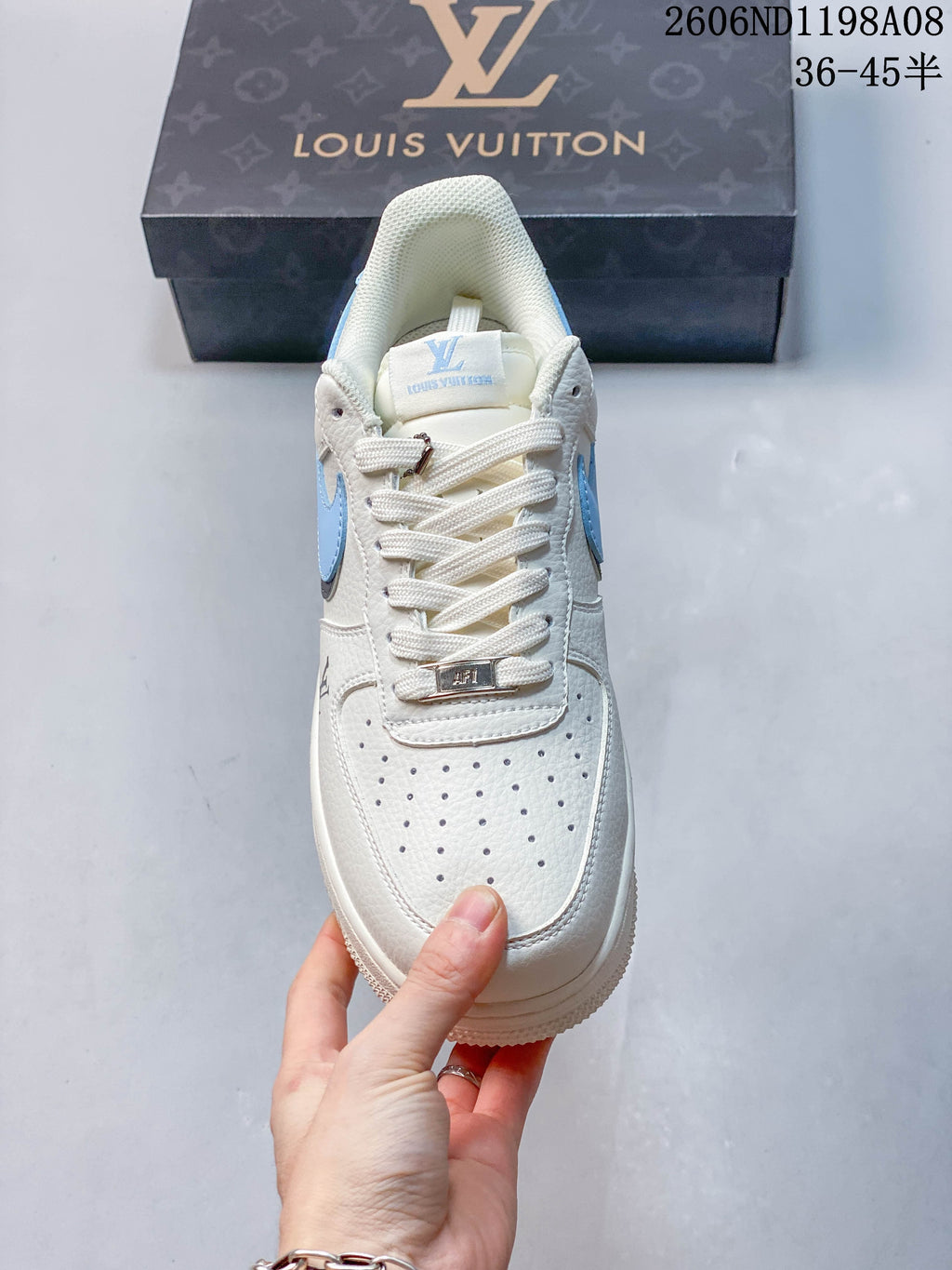 Front view showing perforated toe, white laces, and metallic lace detail
