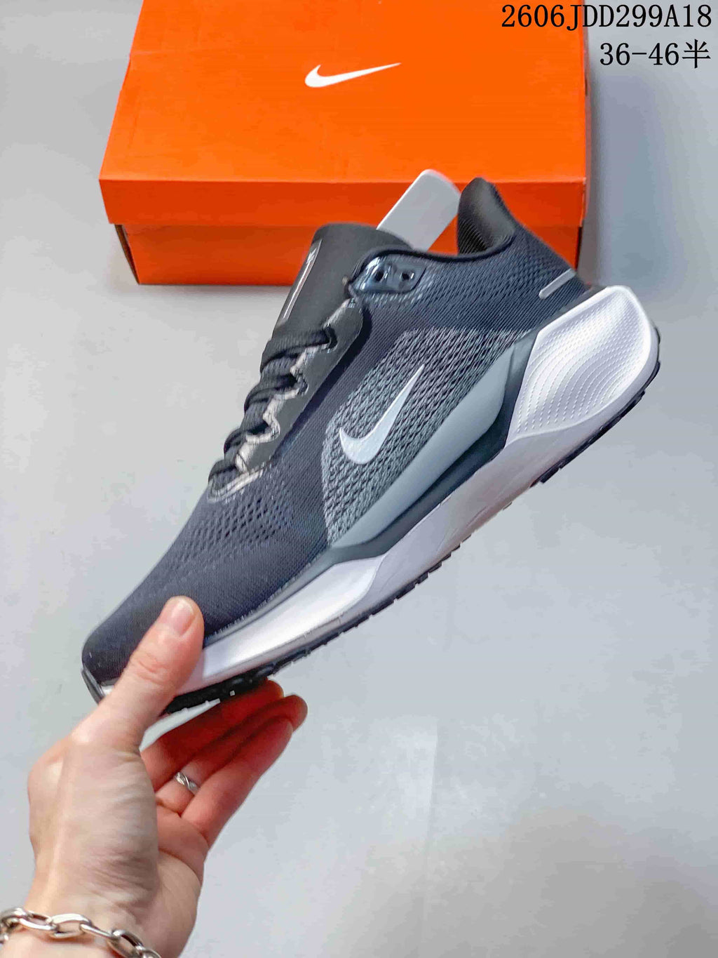 Side view of a dark gray Nike Pegasus running shoe with a white midsole
