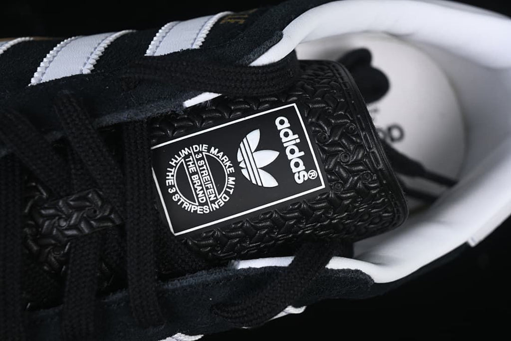 Close-up of the adidas Originals tongue label and black laces.