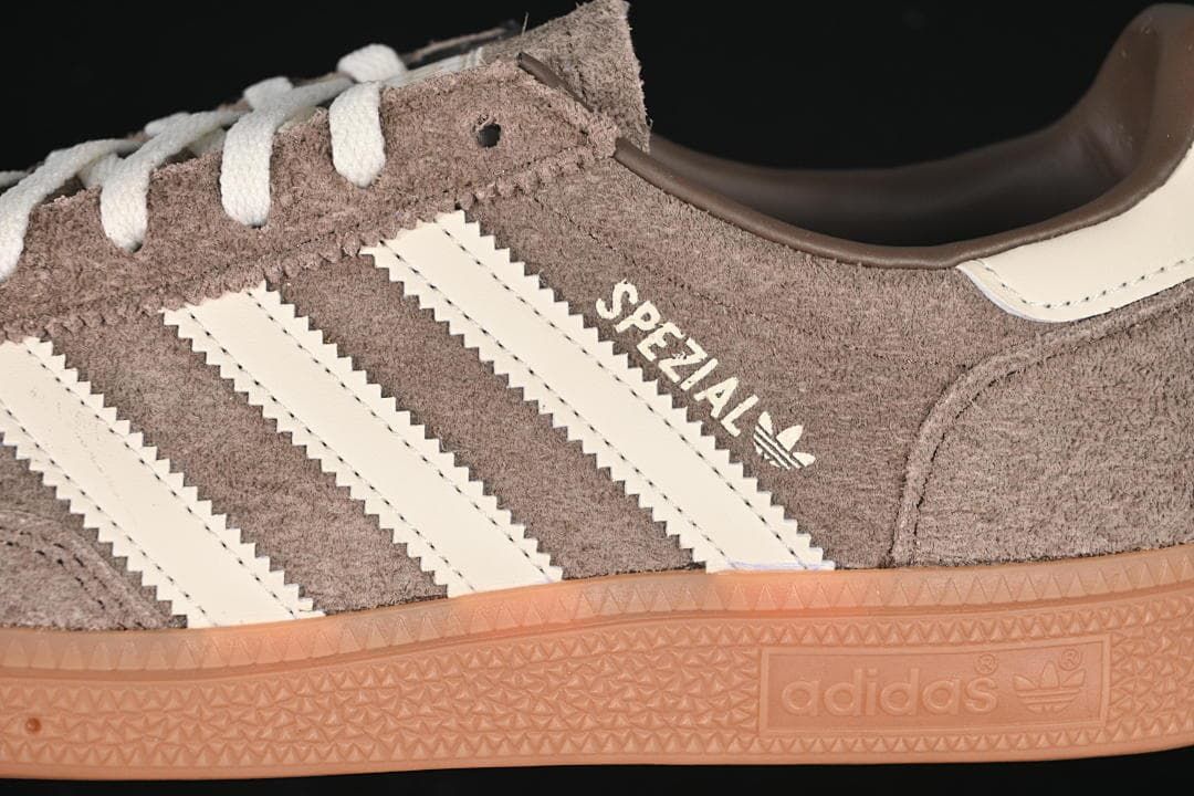 Close-up of cream side stripes, brown upper, and gum-colored sole.