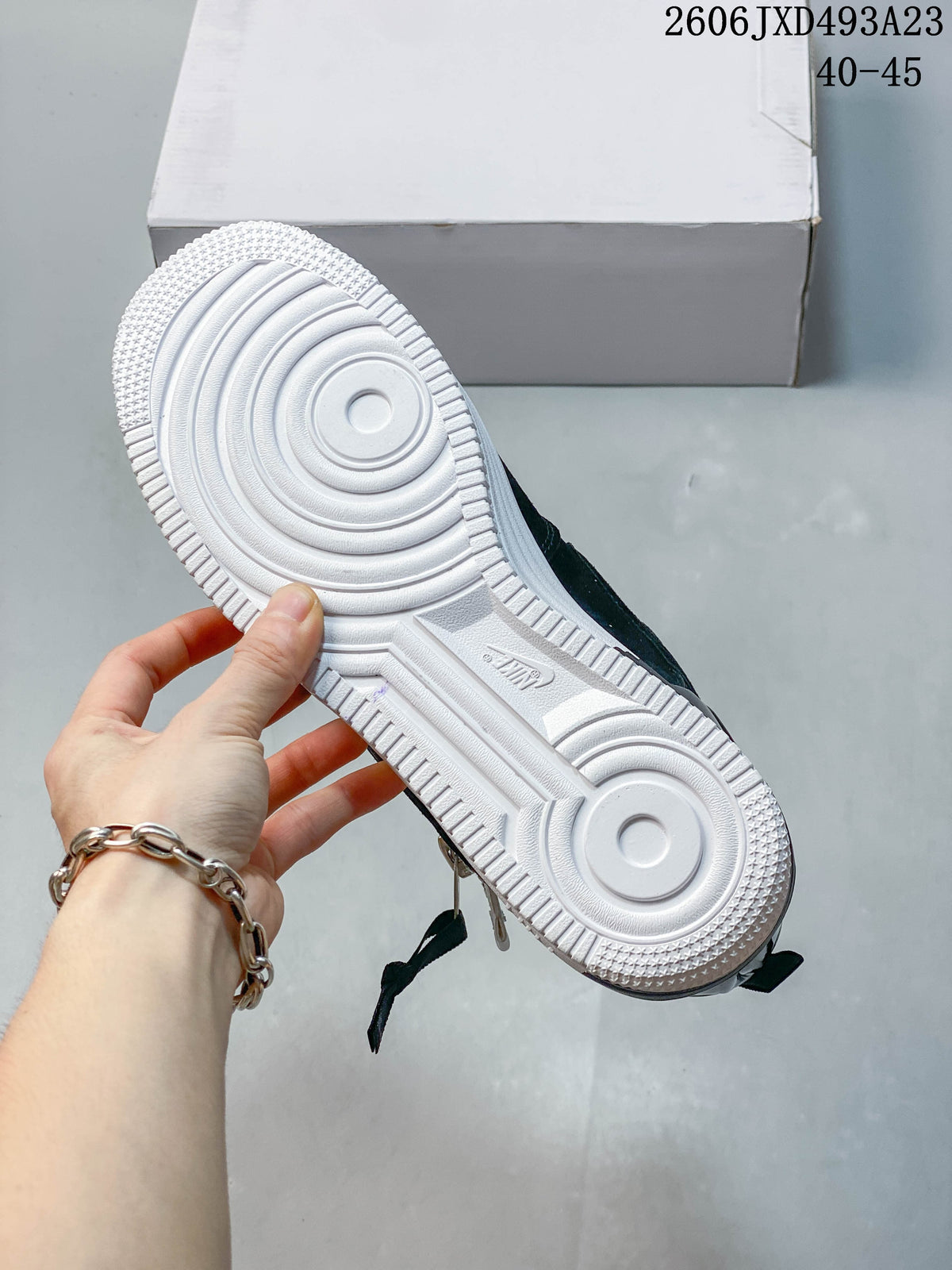 View of the sneaker outsole with circular traction details.