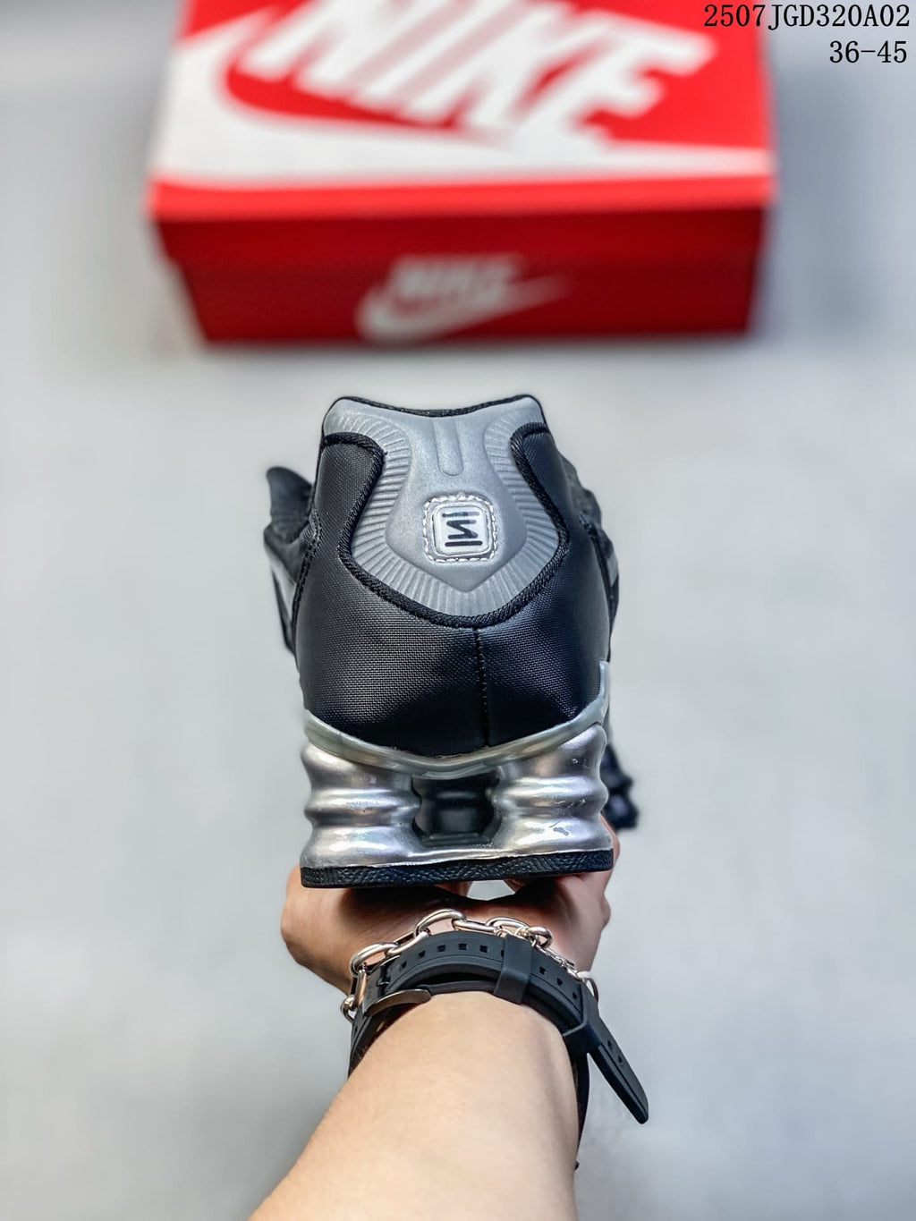 Rear view of the sneaker with a silver heel panel and sculpted sole