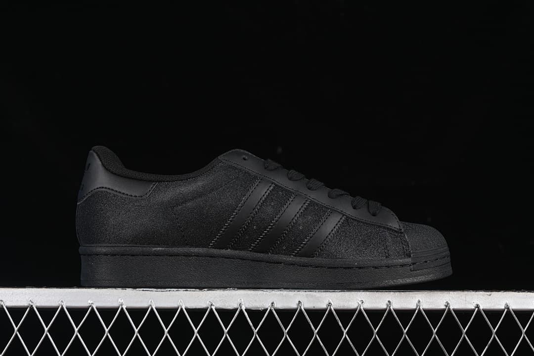 Side profile of the black low-top sneaker with three stripes
