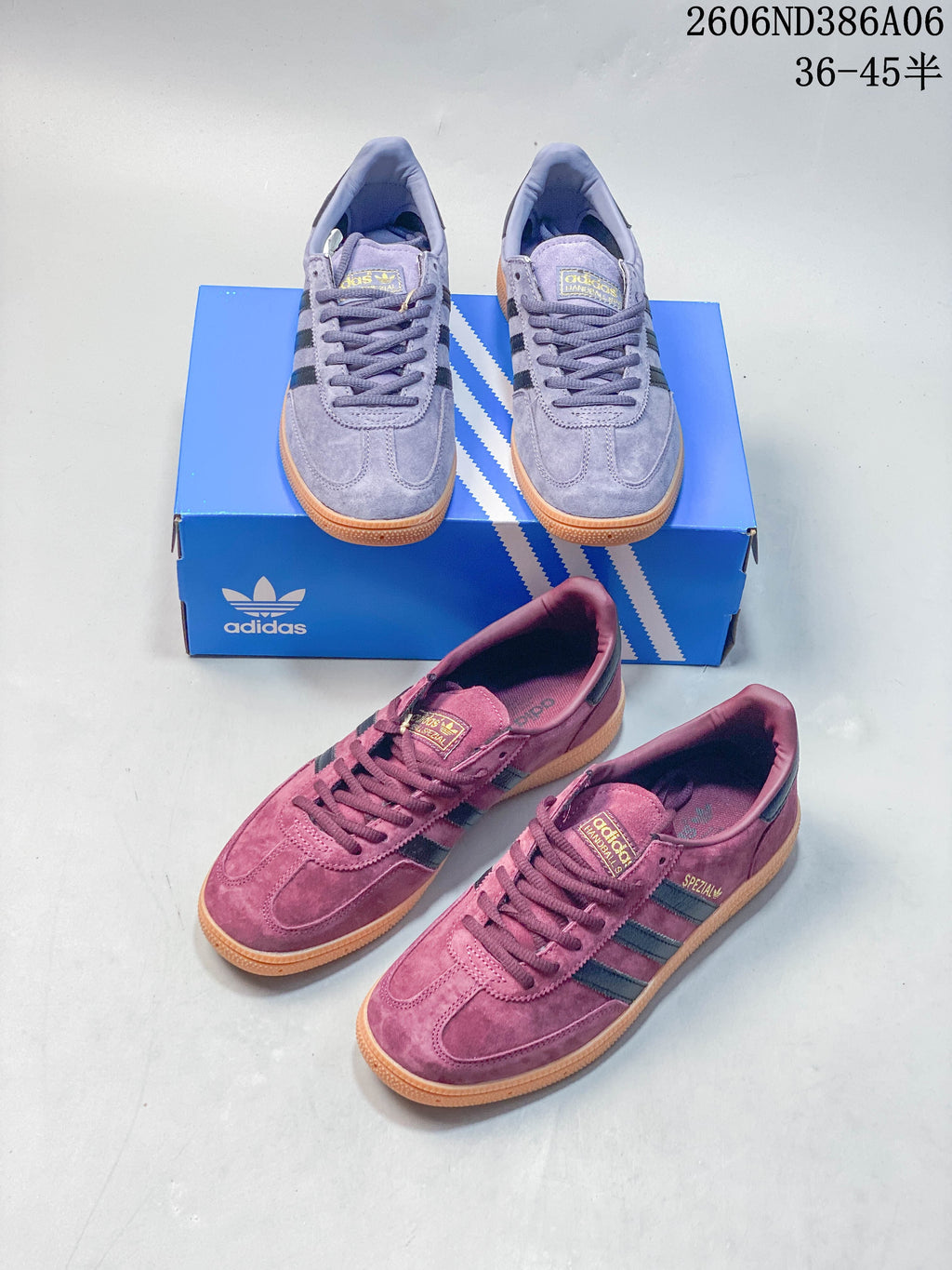 Lavender Adidas Handball Spezial sneakers shown from the side on a blue shoe box