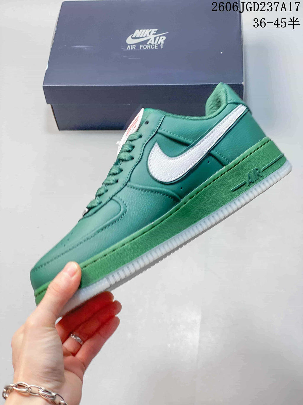 Side view of a teal low-top sneaker with a white Swoosh and green midsole.