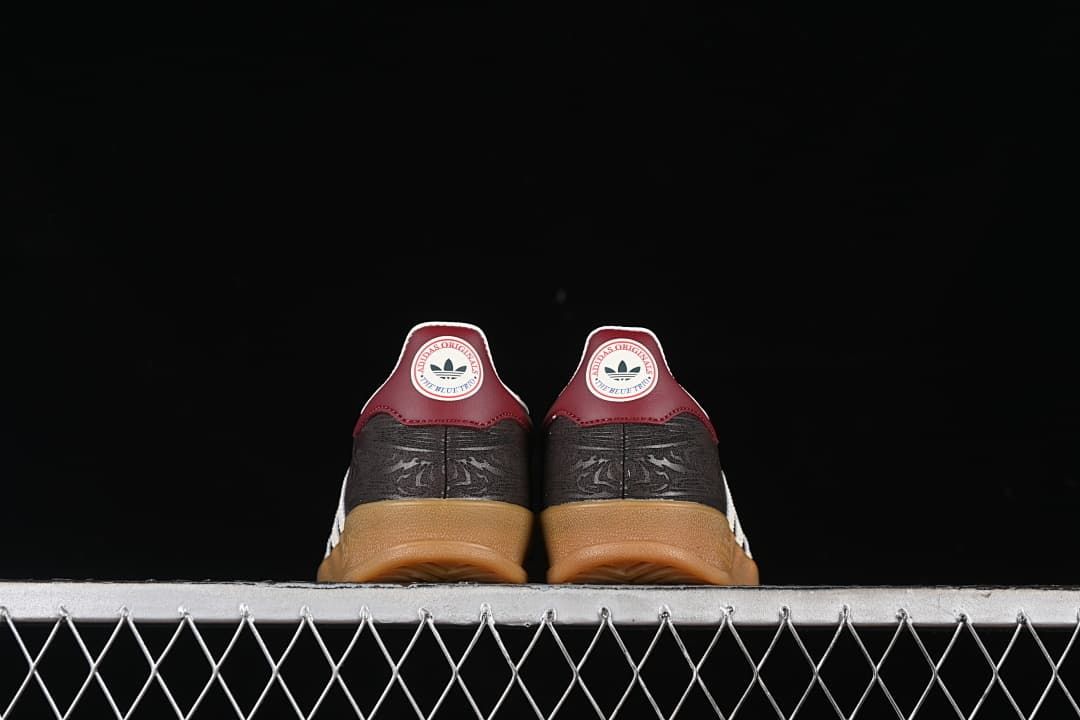 Rear view of both sneakers showing burgundy heel tabs and gum soles.