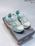 Pair of light sage and off-white ASICS sneakers displayed on a shoebox, with the style code and size range visible above.