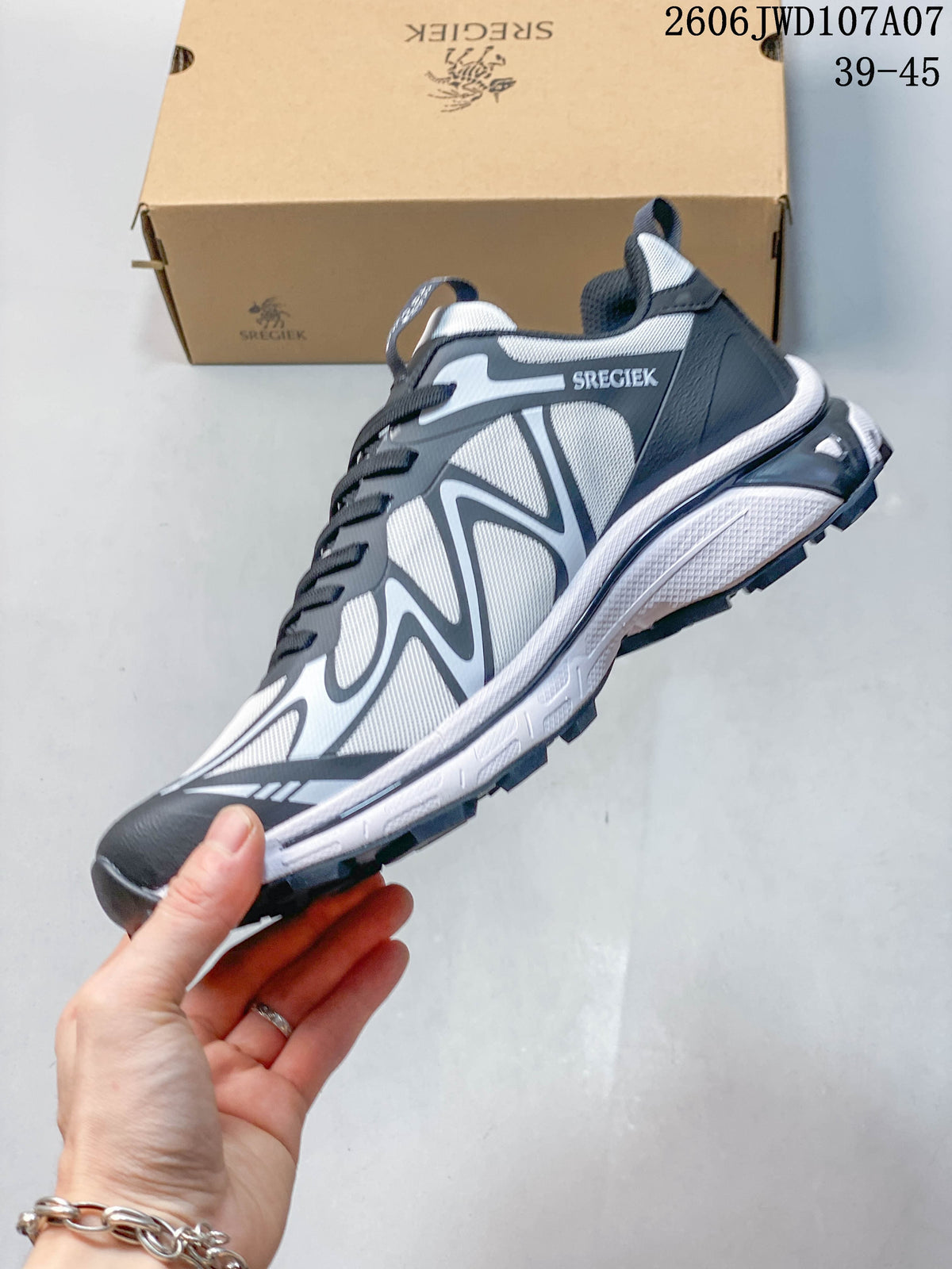 Side view of the gray and white Sregiek low-top hiking shoe with dark laces and a lugged outsole.