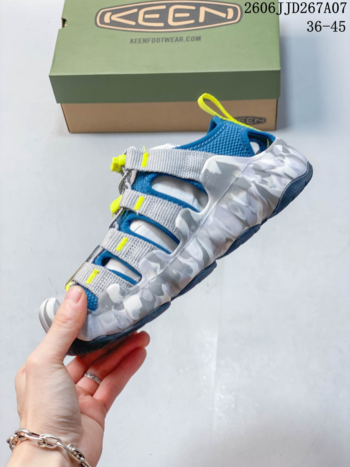 Side view of a KEEN sandal with cage-style straps and patterned panels