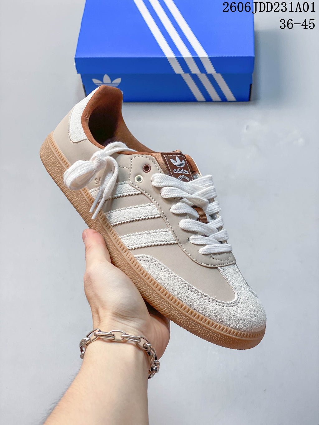 Angled side view of a light neutral Adidas Samba OG sneaker