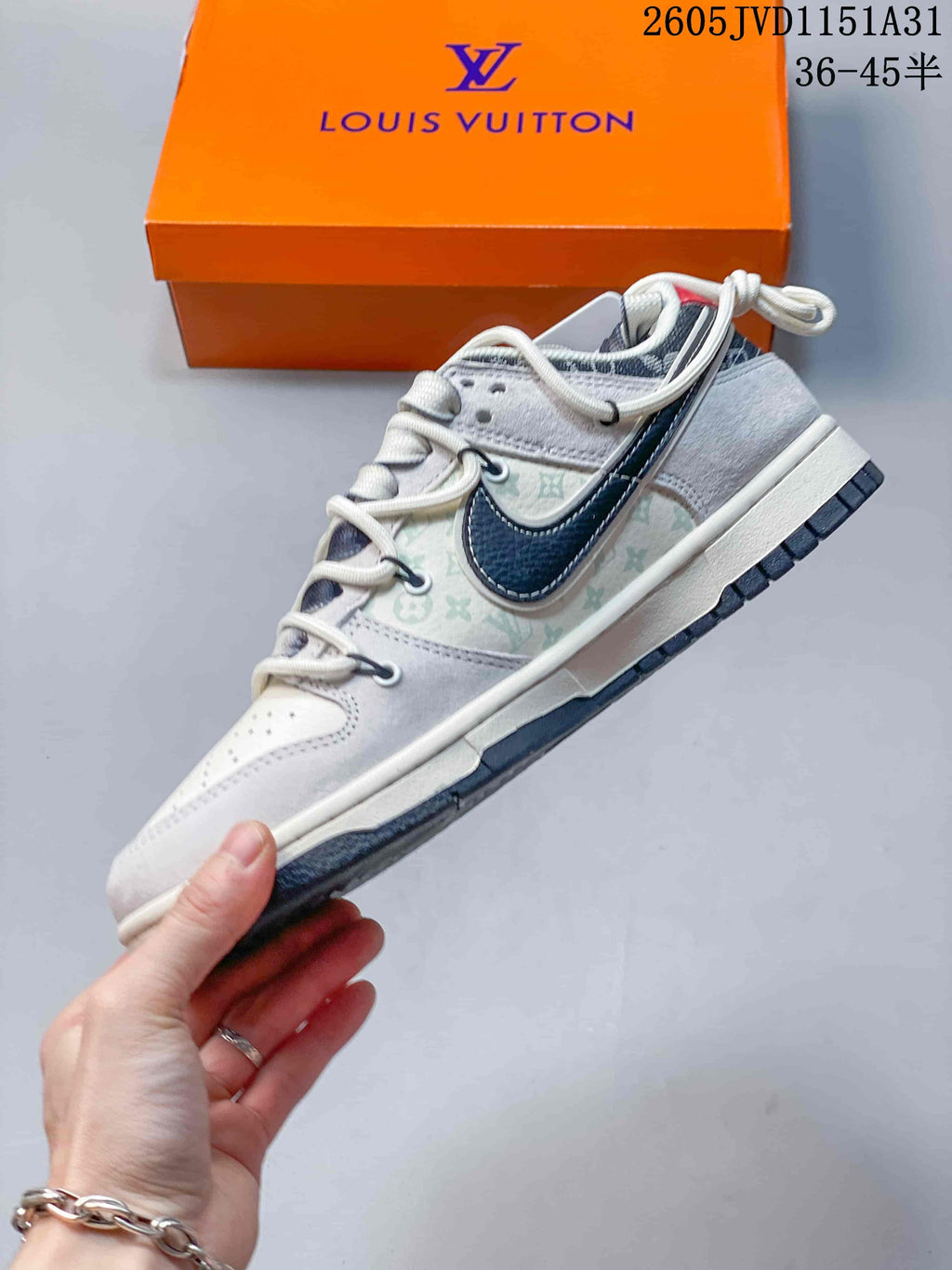 Side view of the low-top sneaker with a dark side swoosh and patterned panels.