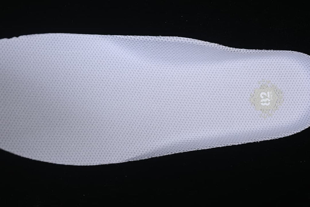 Close-up of the textured insole with a small printed emblem.