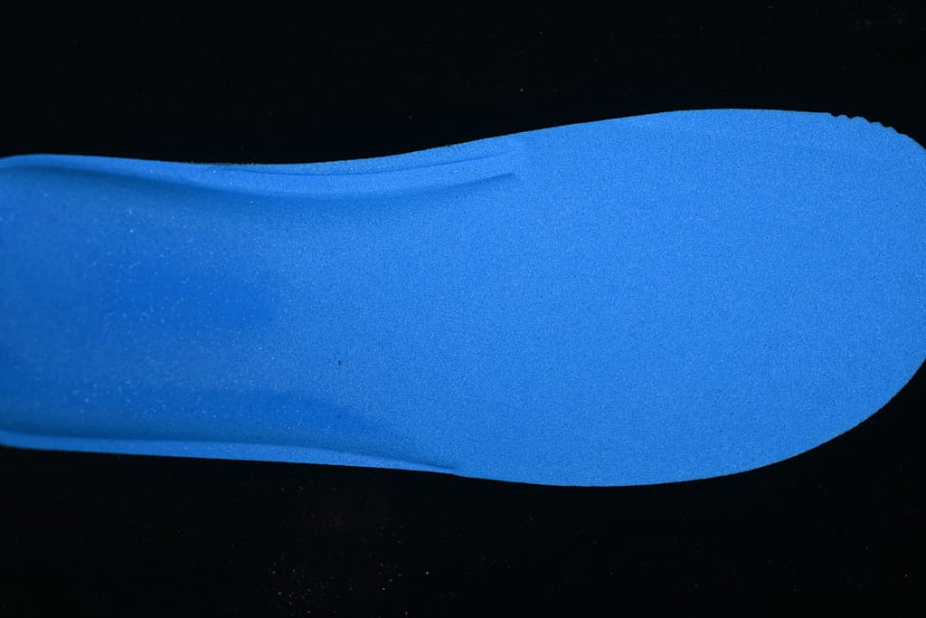 Blue shoe insole shown against a dark background.