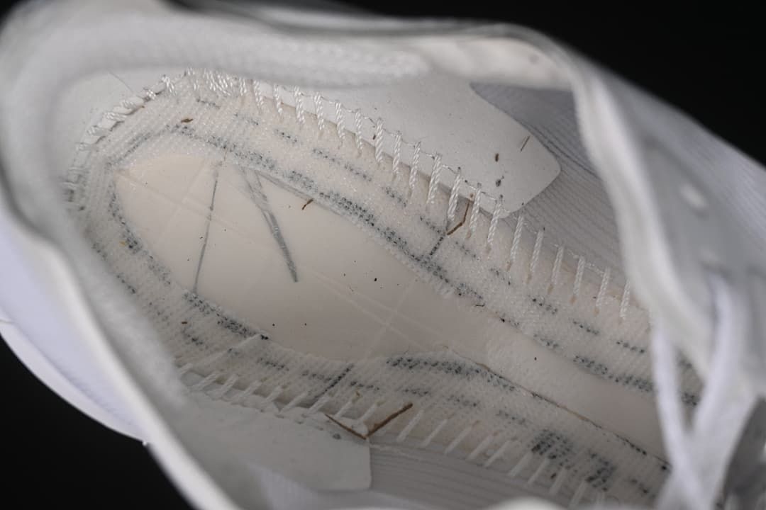 Interior construction detail inside the white running shoe.
