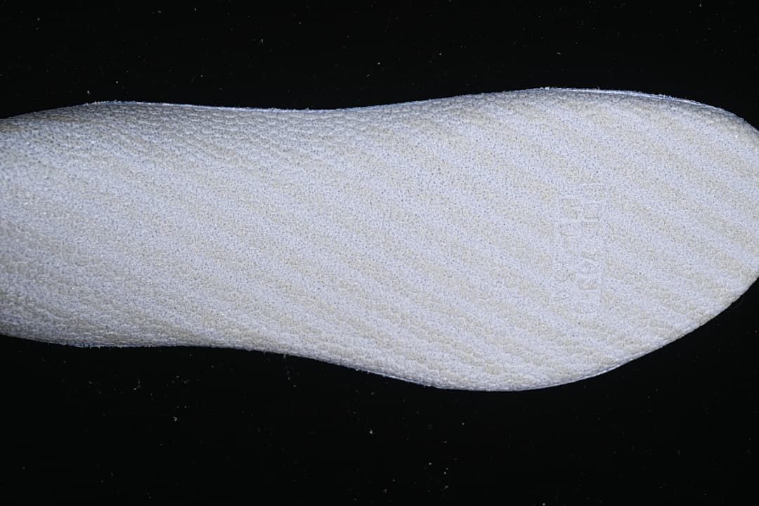 Close-up of a light-colored textured shoe component
