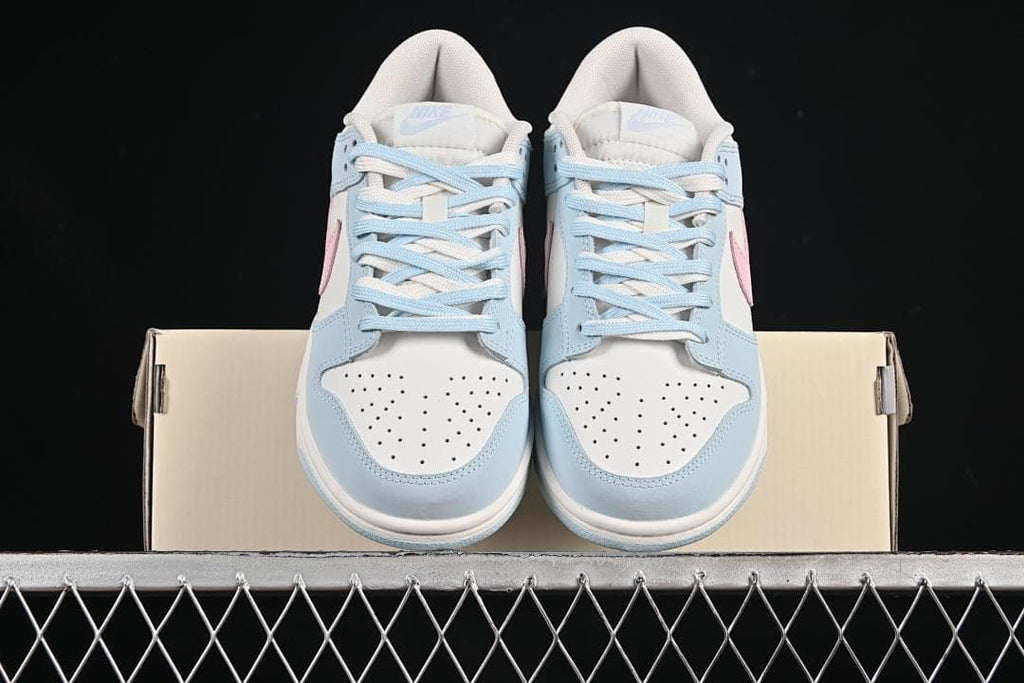 Front view of both sneakers resting on a shoebox
