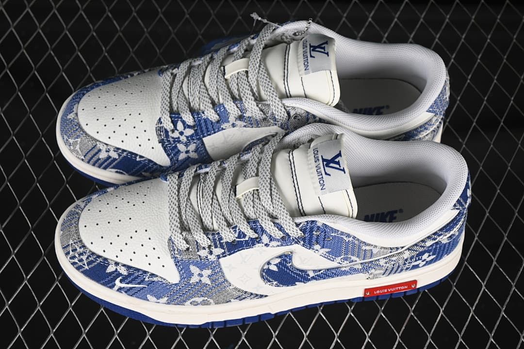 Top view of a pair of blue-and-white patterned Nike SB Dunk Low sneakers with perforated toe panels