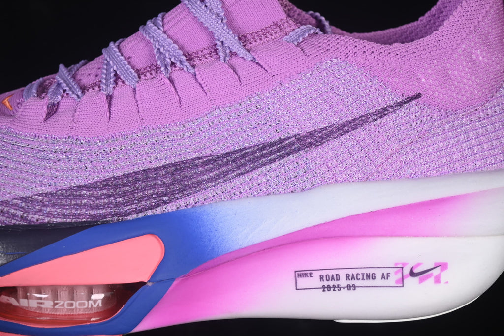 Close-up of the purple shoe upper, dark Swoosh, and blue-to-pink midsole details.