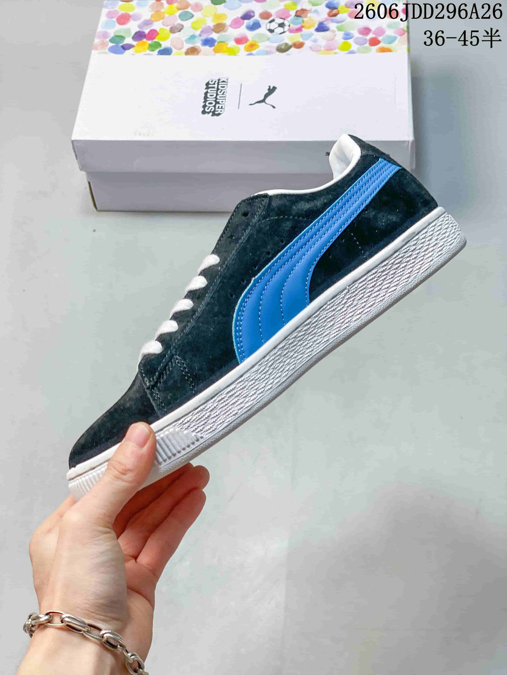 Side profile of a dark low-top sneaker with a bright blue stripe and white sole.