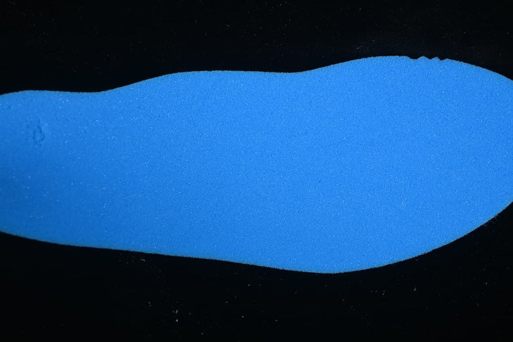 Blue shoe insole shown against a dark background