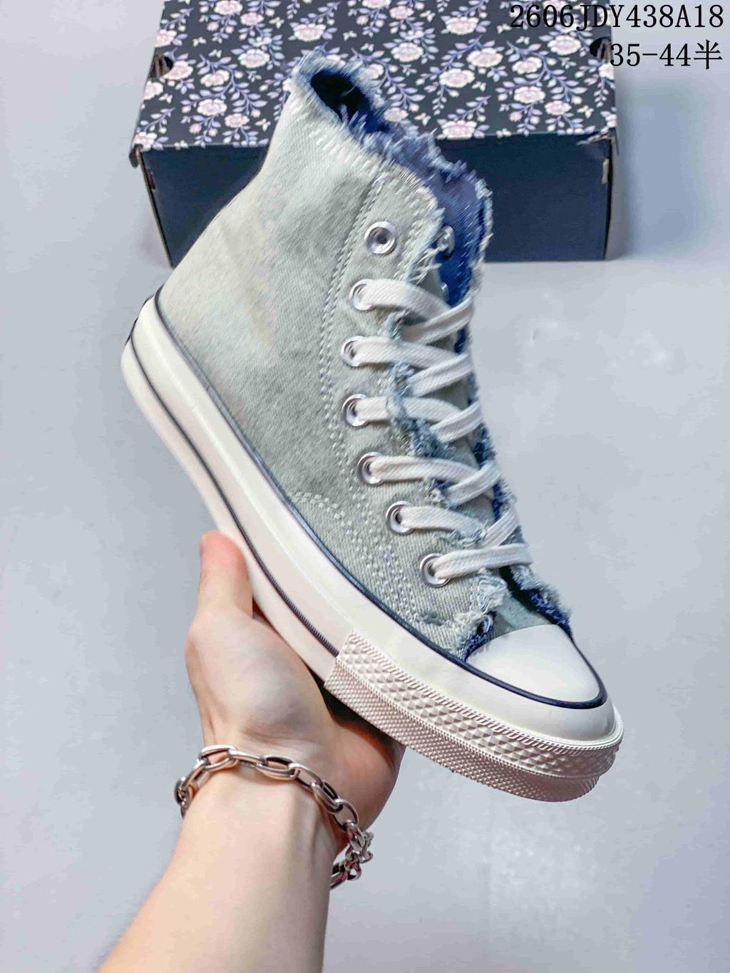 Angled side view of the washed denim high-top sneaker