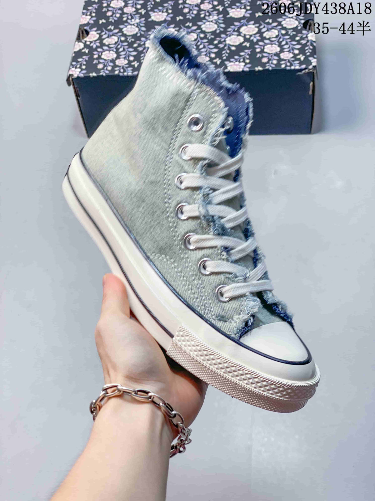 Angled side view of the washed denim high-top sneaker