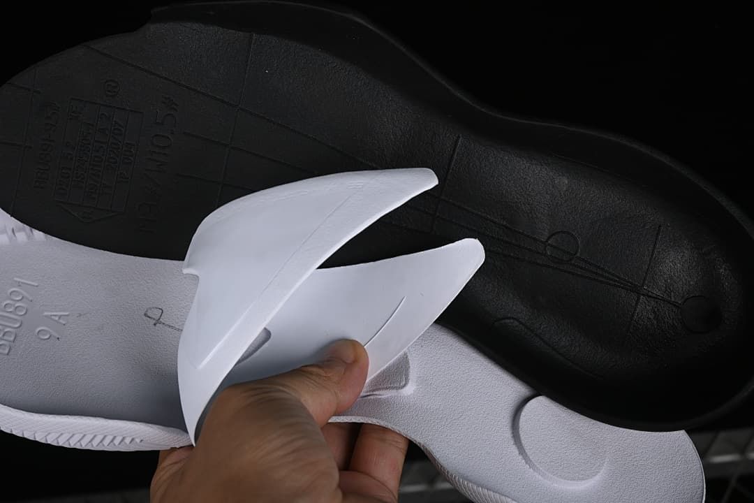View of the shoe's separated insole and outsole.