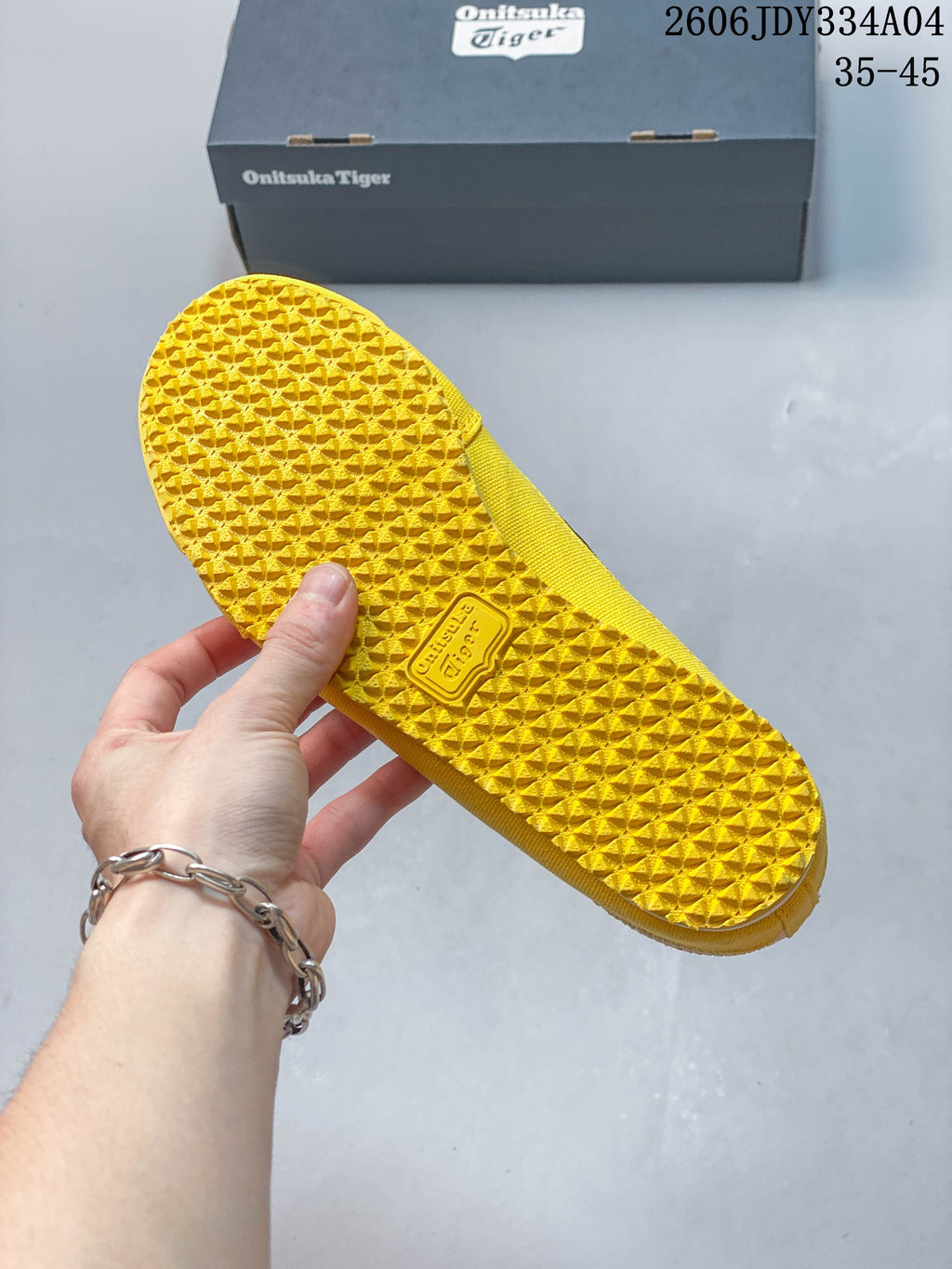 Close-up of the textured yellow outsole of the Mexico 66 Sabot shoe.