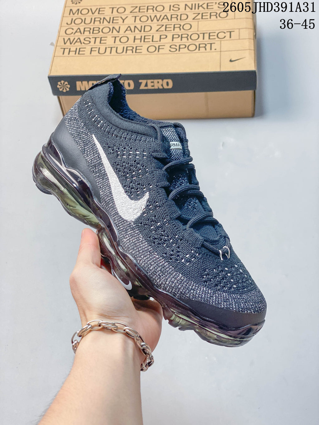 Side view of a navy Nike Air VaporMax Flyknit shoe with a visible full-length sole unit