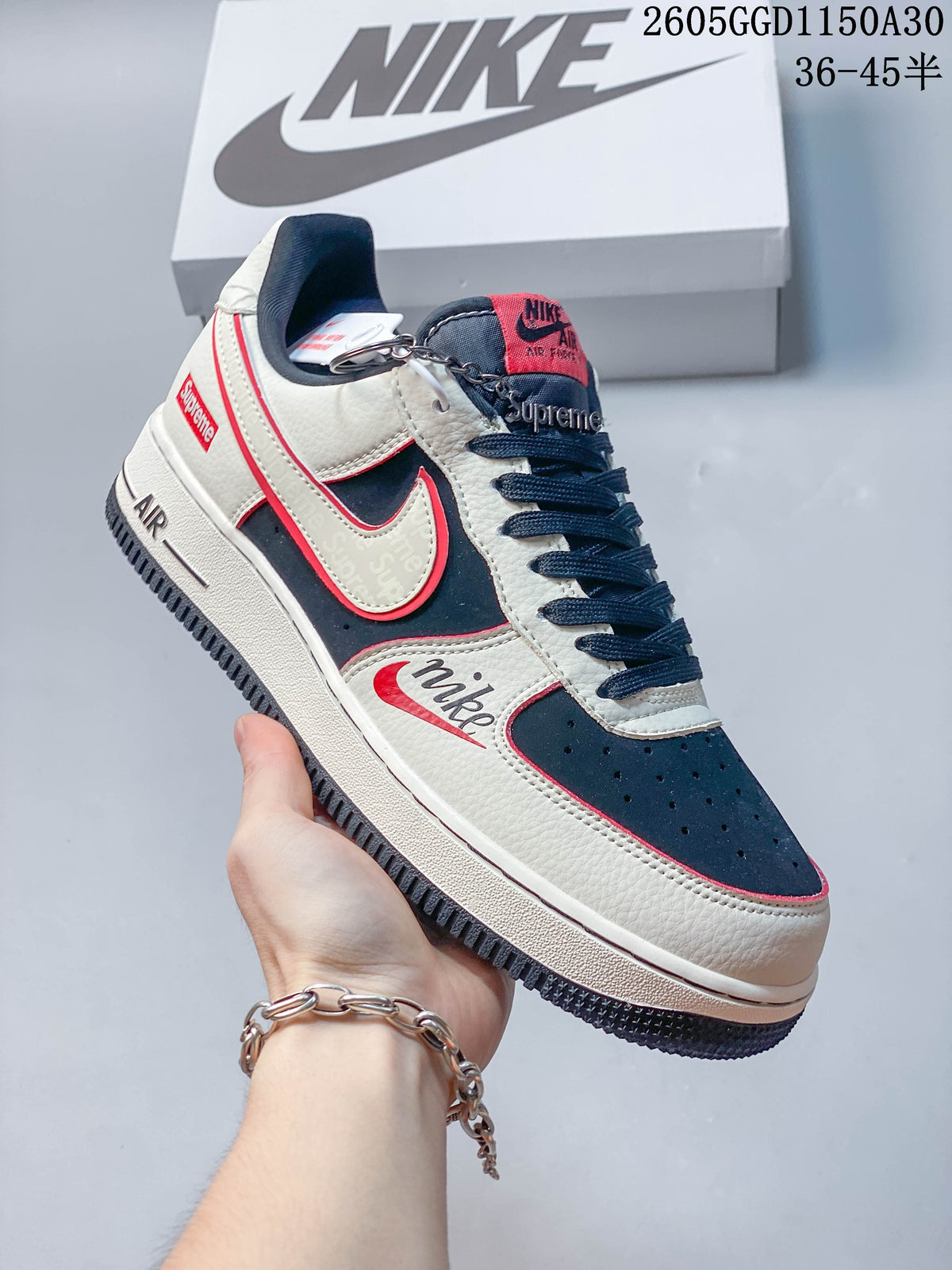 Angled side view showing the sneaker’s cream, navy and red color blocking