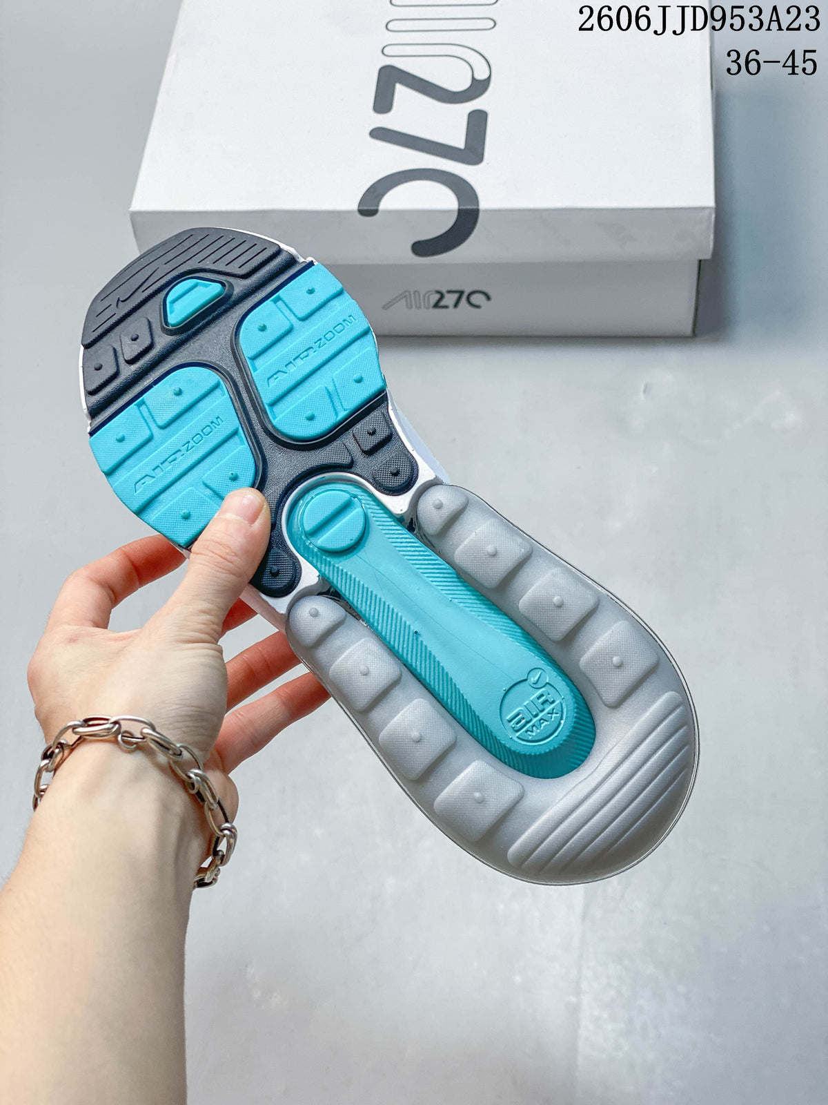 Underside view showing the teal and gray outsole and Air Max branding.