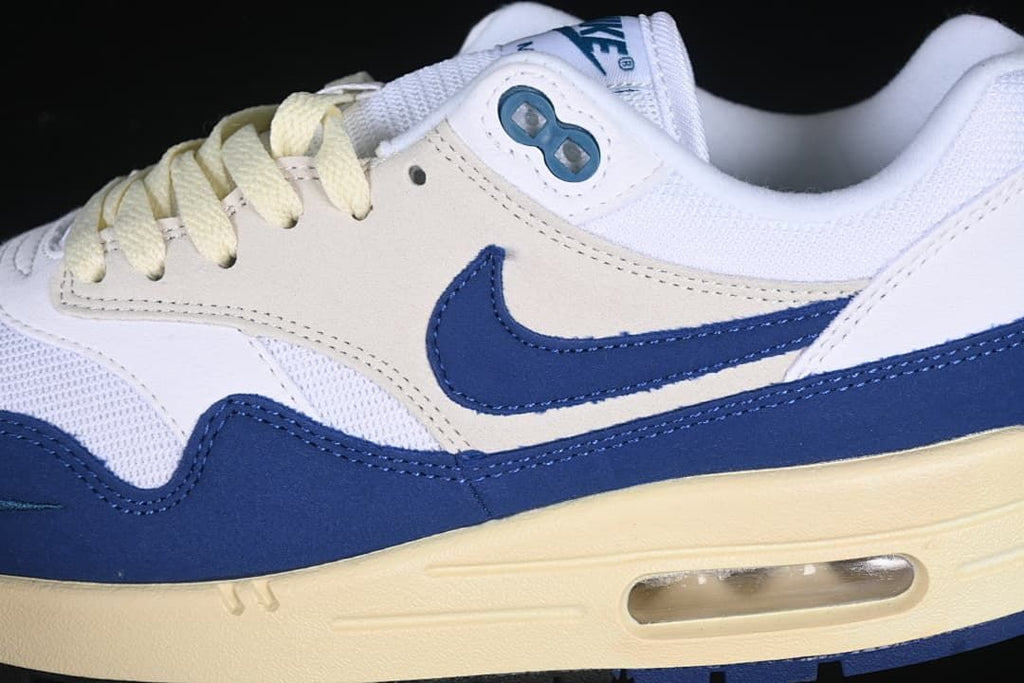 Close-up of the navy Swoosh, layered upper and visible heel Air unit