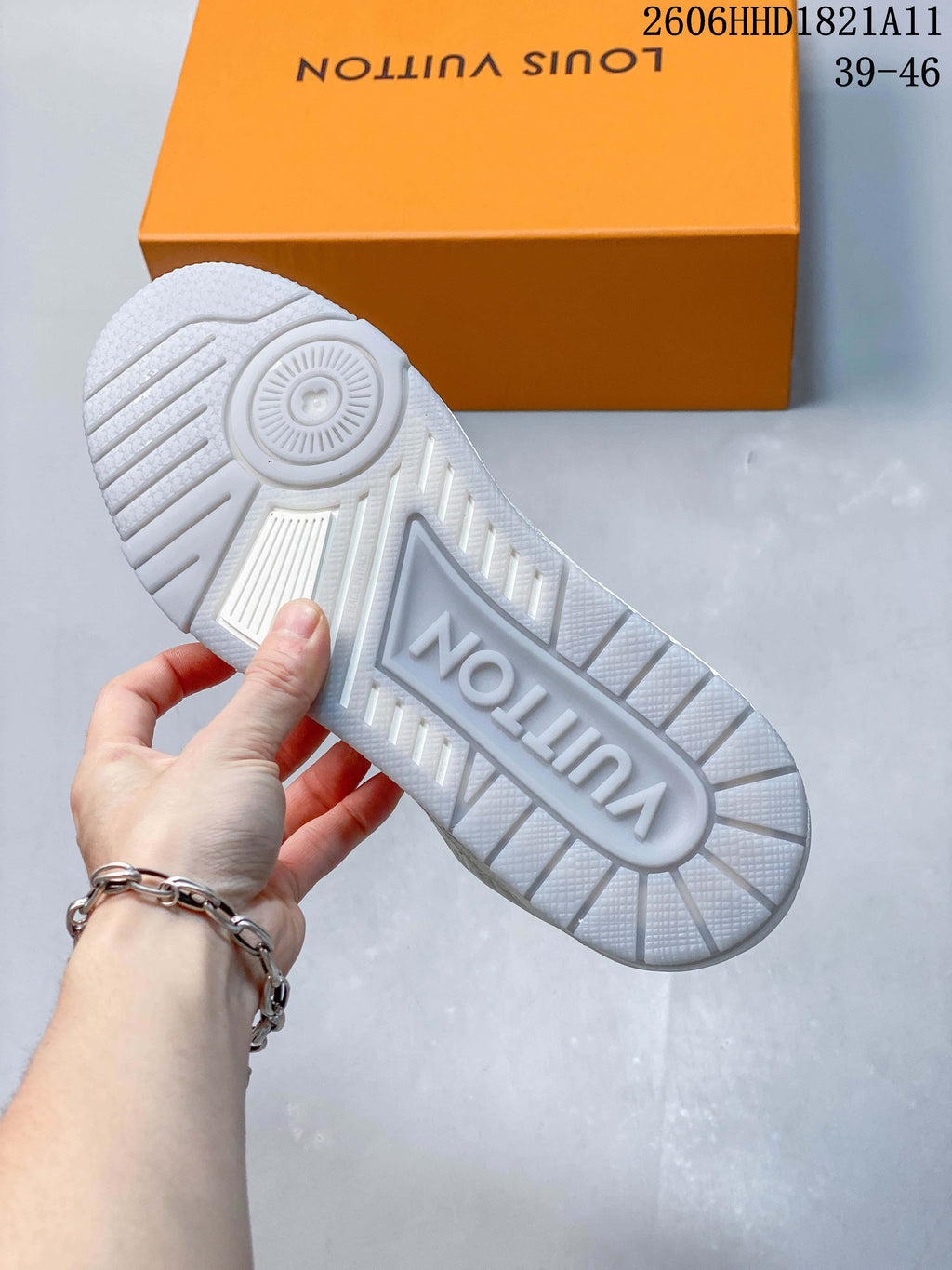 Close-up of the white sneaker outsole with patterned tread.