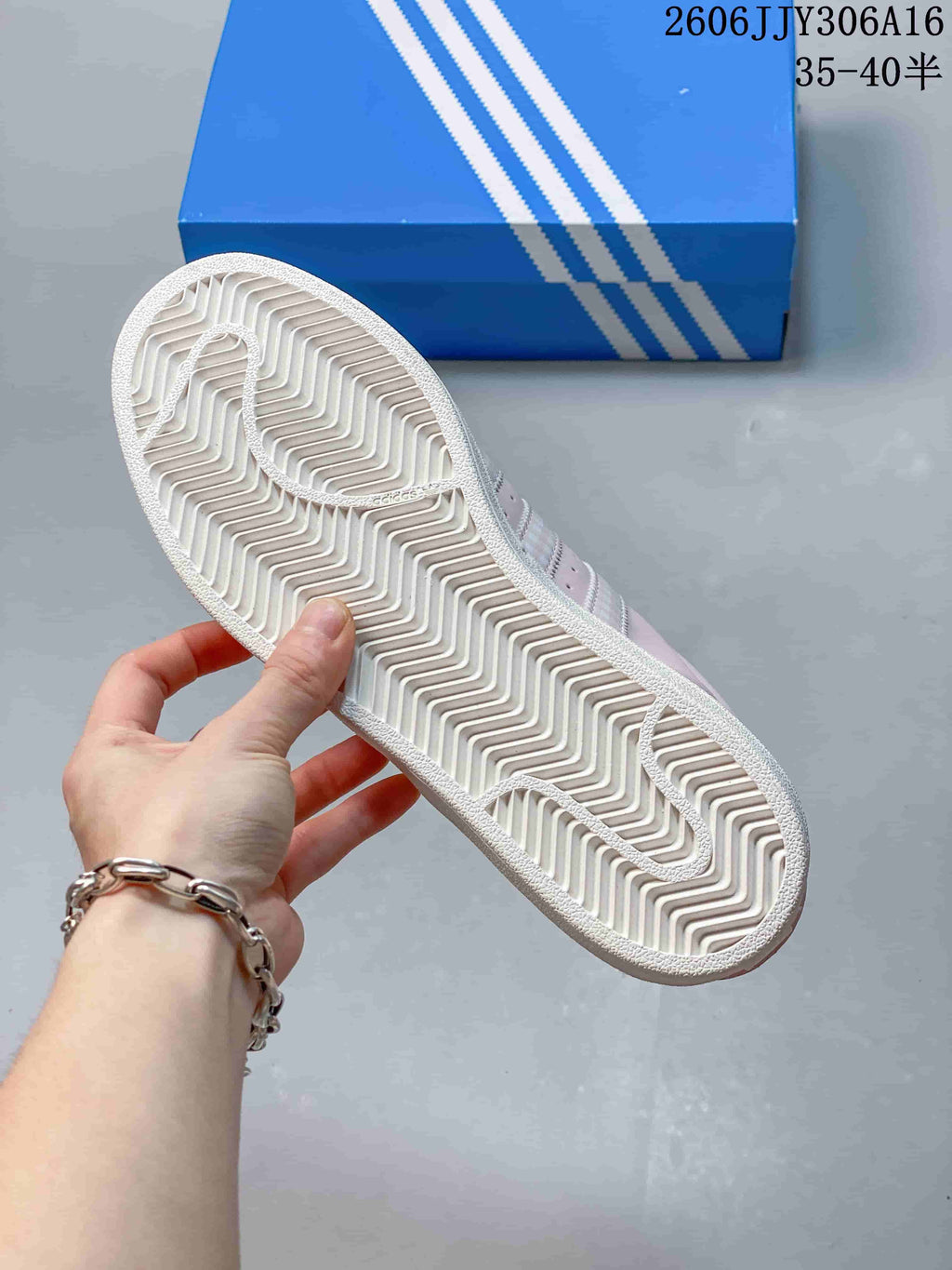 Underside of a sneaker showing its patterned white outsole