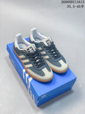 Pair of blue and cream adidas Originals Samba OG low-top sneakers on a blue box