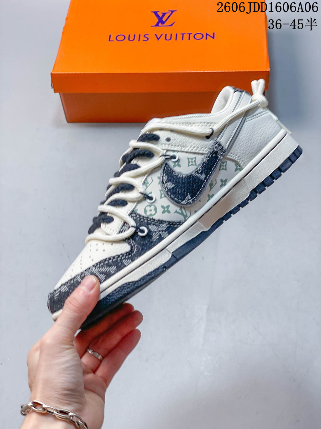 Side view of the cream and navy patterned low-top sneaker.