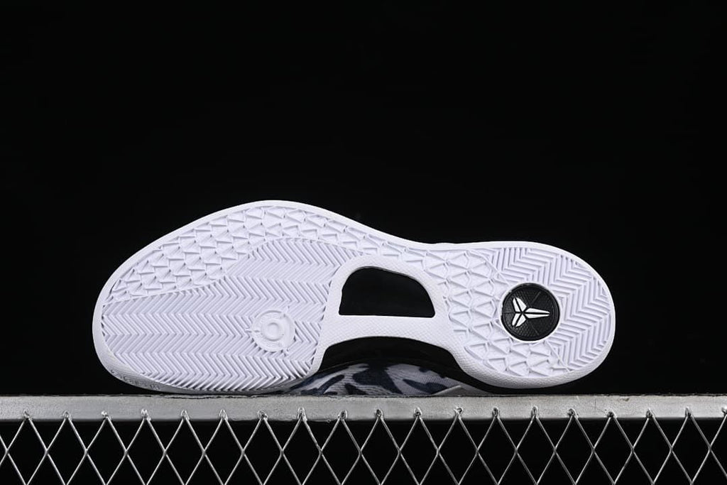 Underside of the shoe showing the white outsole and traction pattern.