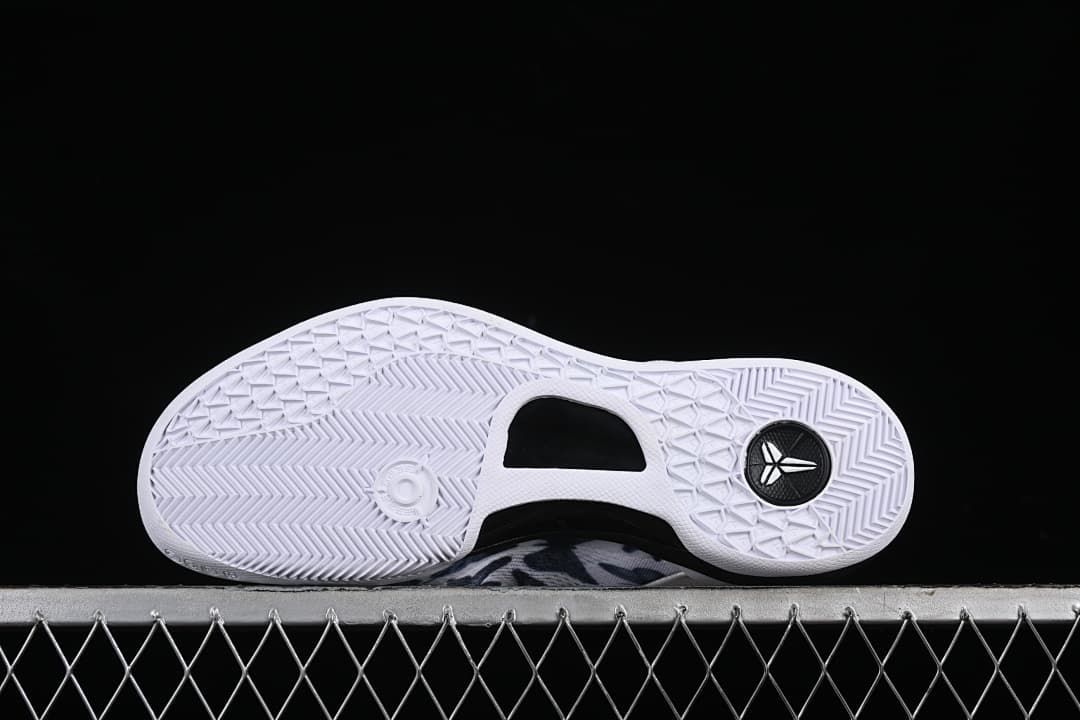 Underside of the shoe showing the white outsole and traction pattern.
