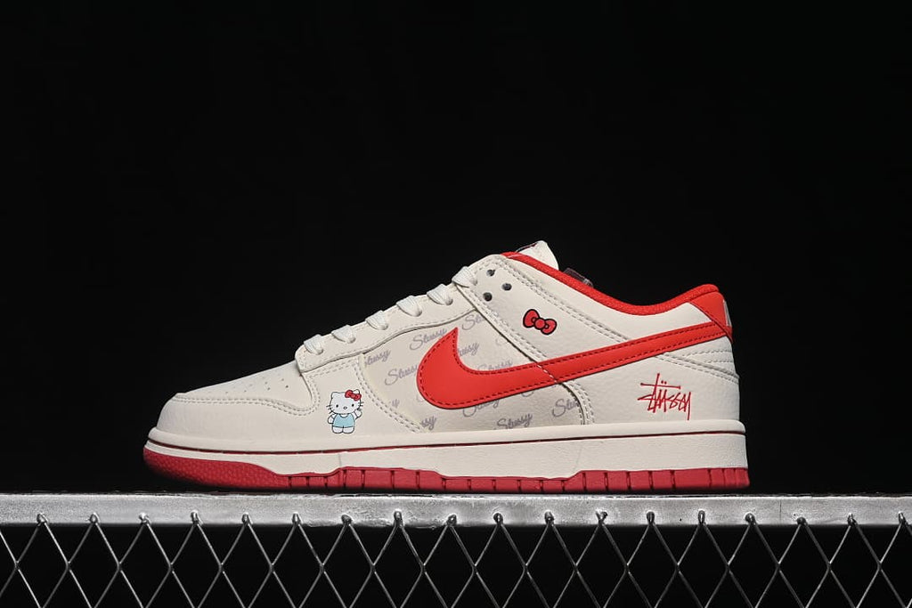 Side view of a white and red low-top sneaker with Hello Kitty graphics and a red Swoosh.