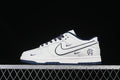 Side view of a white and navy Nike SB Dunk Low with Reigning Champ branding.