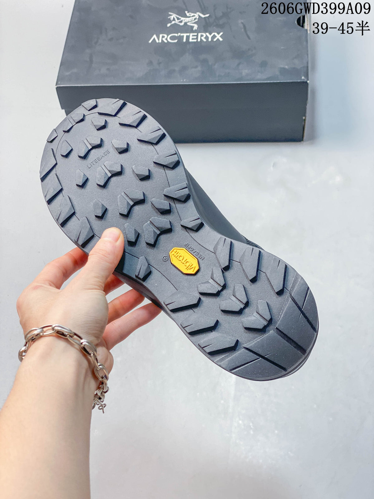 Close-up of the shoe's lugged outsole and box