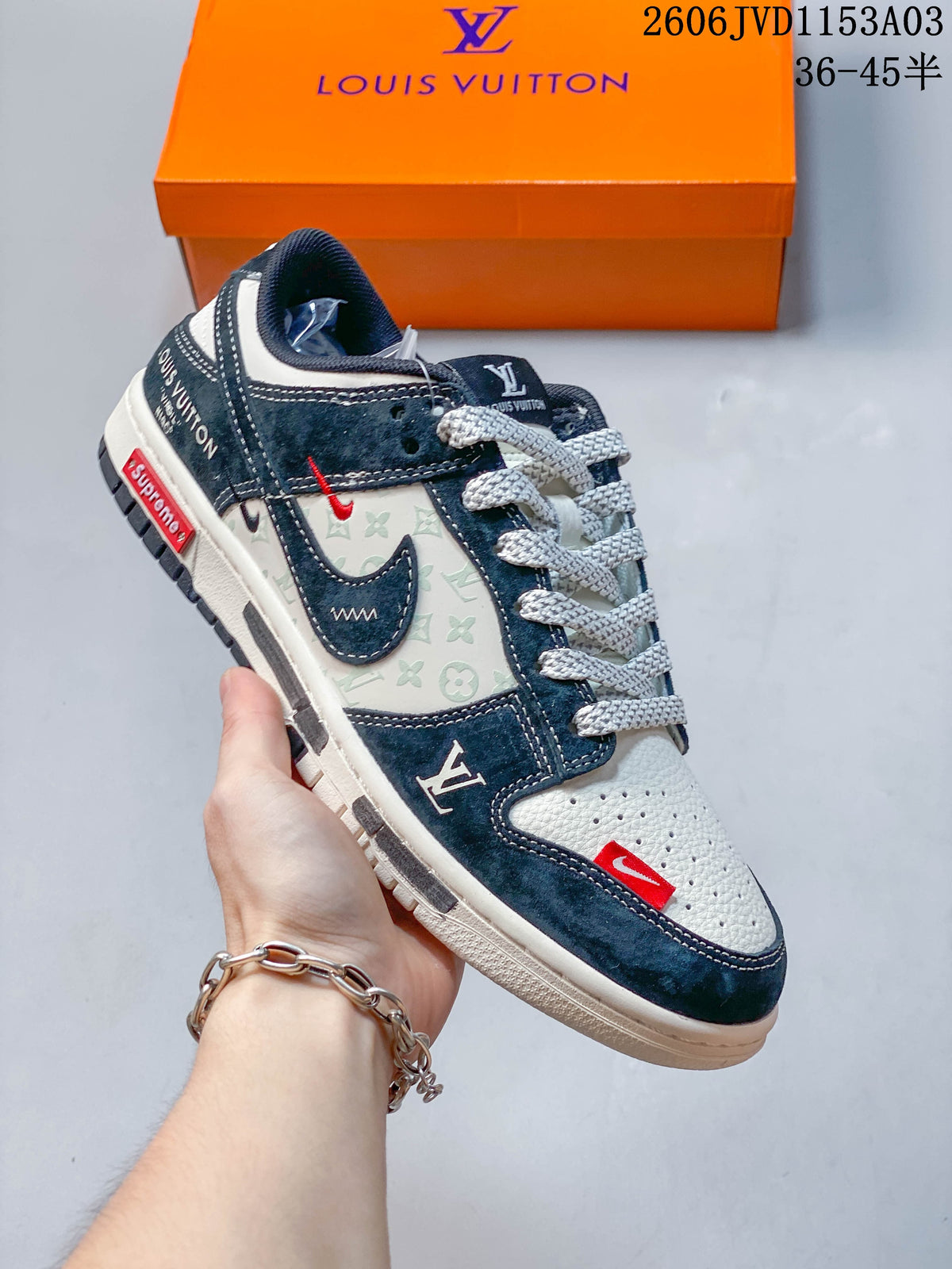 Navy and light gray low-top sneaker with patterned side panels and contrast accents