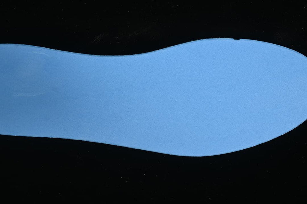 Blue shoe insole shown against a dark background