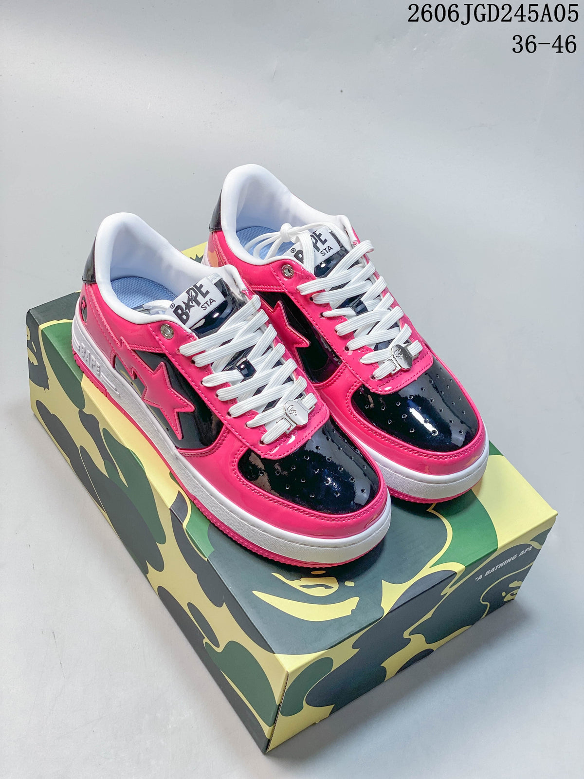 Pink, black and white BAPE STA low-top sneakers shown on a camouflage-patterned box