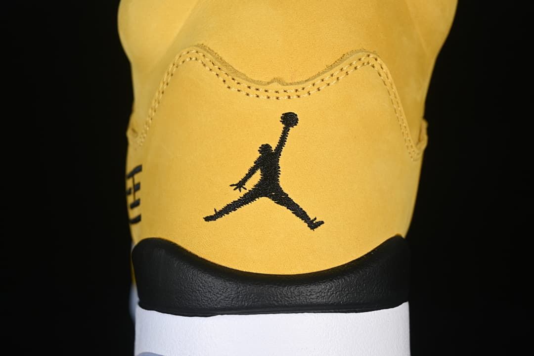 Close-up of the yellow heel with a black Jumpman logo