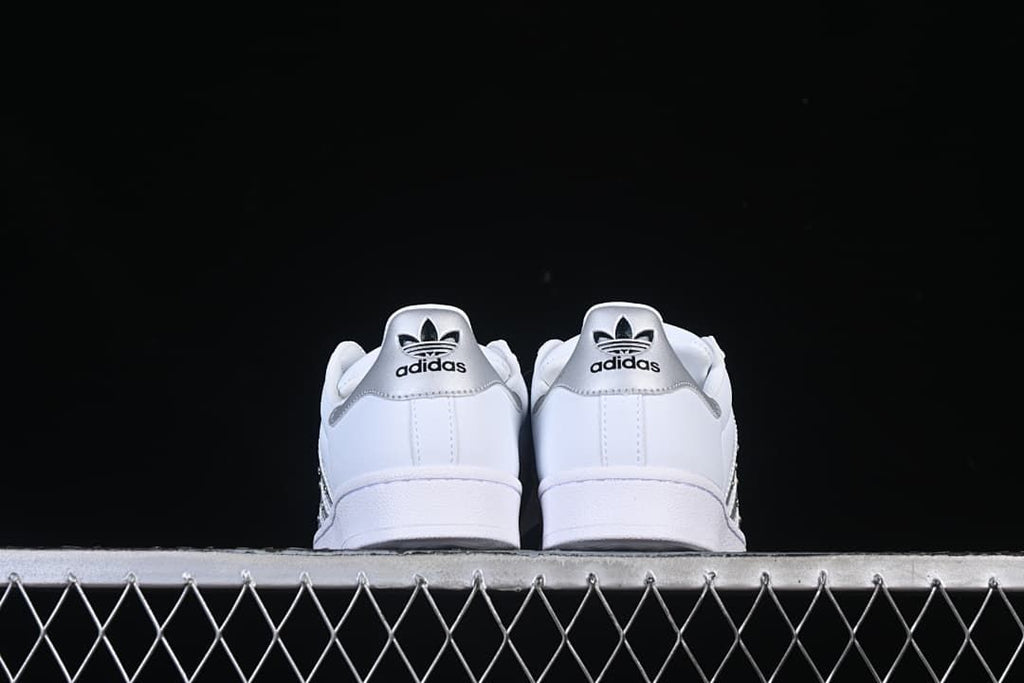 Rear view of both sneakers with silver heel panels