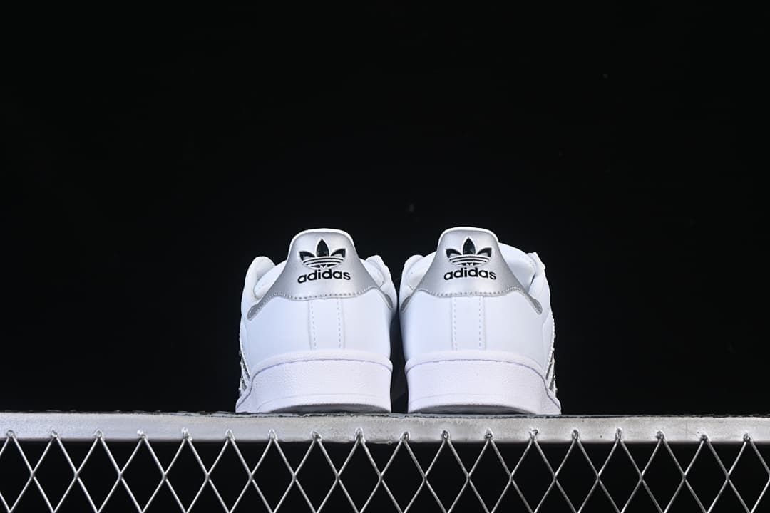 Rear view of both sneakers with silver heel panels
